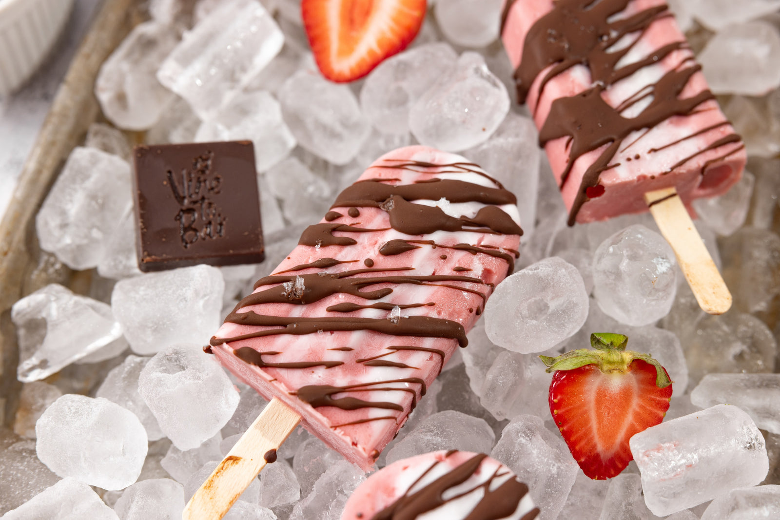 chocolate-drizzled-strawberry-popsicles-on-ice