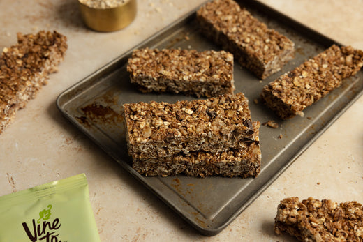 close-up-granola-bars-with-chocolate-chunks-on-gray-baking-tray