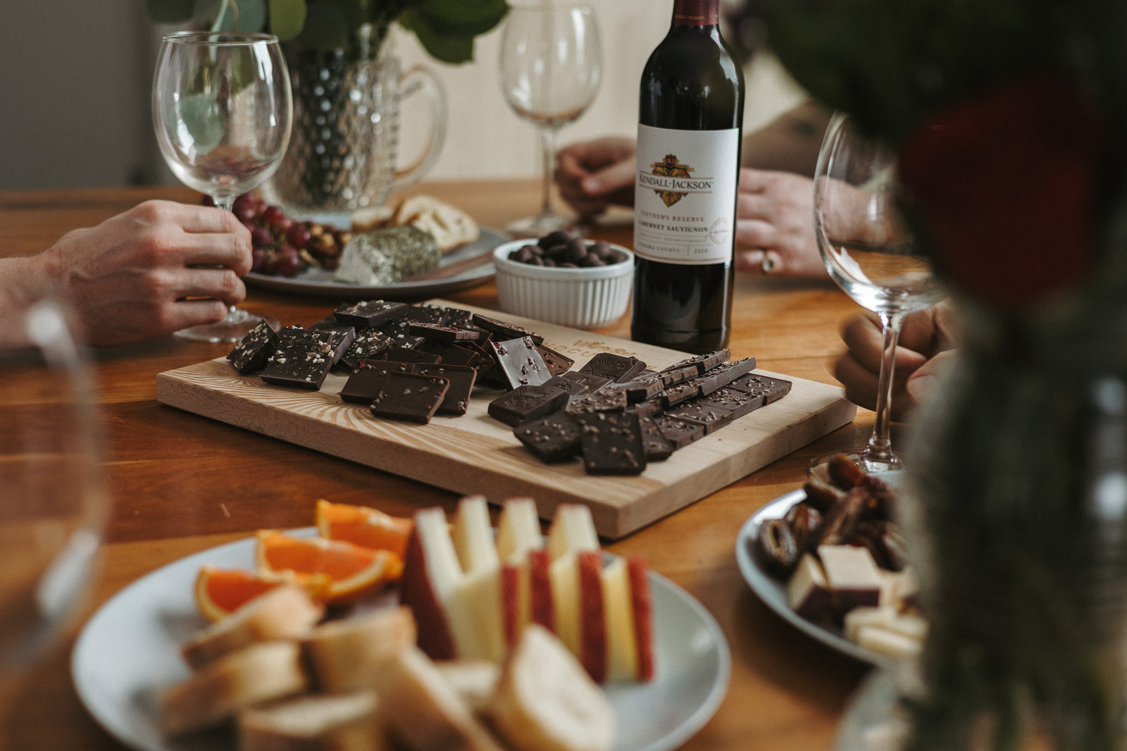 empty-wine-glasses-board-of-chocolate-squares-on-table